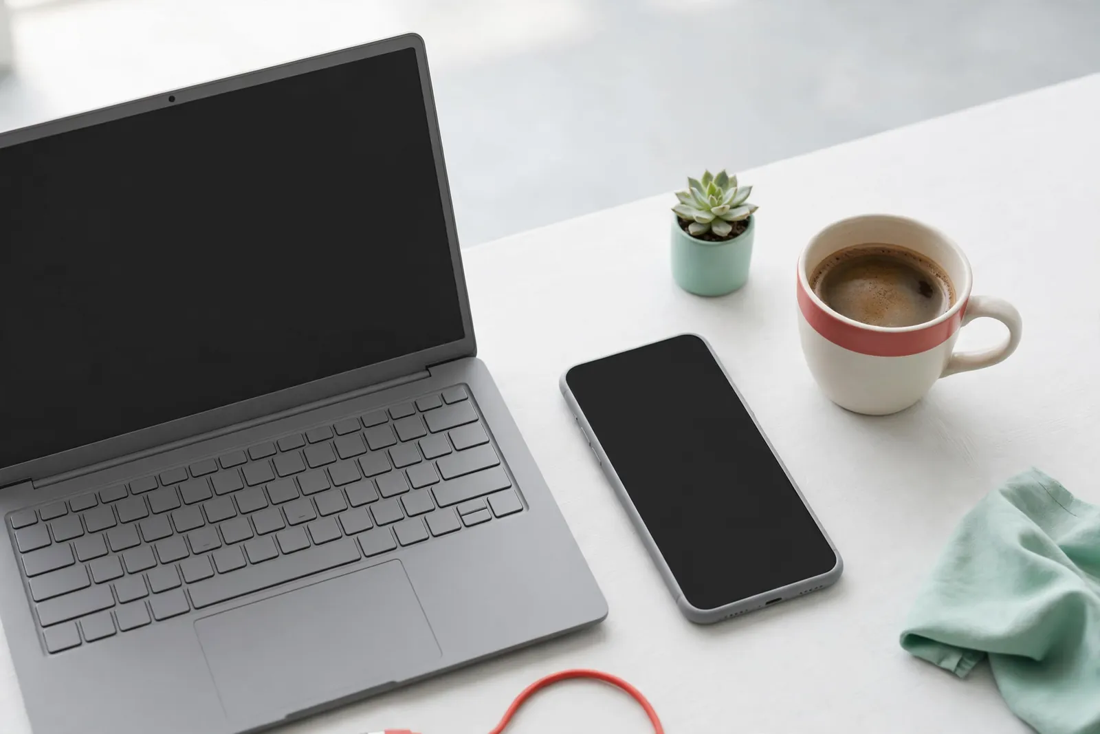 A laptop and a phone on a desk